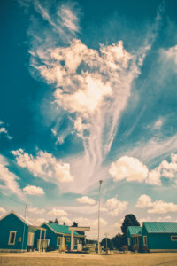 clouds with cone shape close to blue houses clouds with cone shape close to blue houses